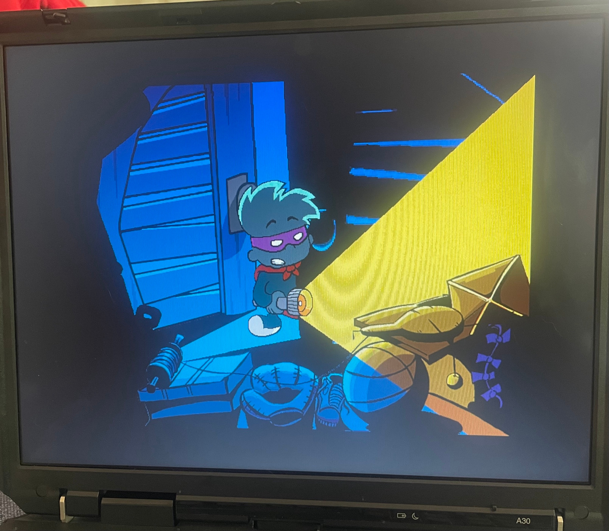 Photo of my laptop screen playing the intro to Pajama Sam in No Need to Hide When It's Dark Outside. Sam is shining his torch into his bedroom closet. 